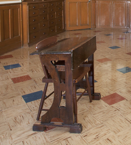 Wooden desk. Wooden chair with backrest. Small sized. Shelf under the desk to store pencils and books