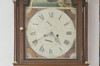 Brown wood Grandfather clock. Roman numeral. Up the dial, a ship. Arched top finish, carved and ornated with three gilded spindle.