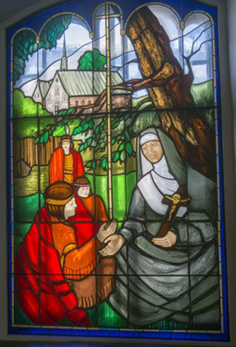 Rectangular colorful Stained-glass window. Arched top. Illustration of Marie of the incarnation teacher under an ash tree.