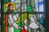Tall Rectangular Stained-glass window in arch, colorful. Illustration of Jesus showing the monastery to Marie of the Incarnation.